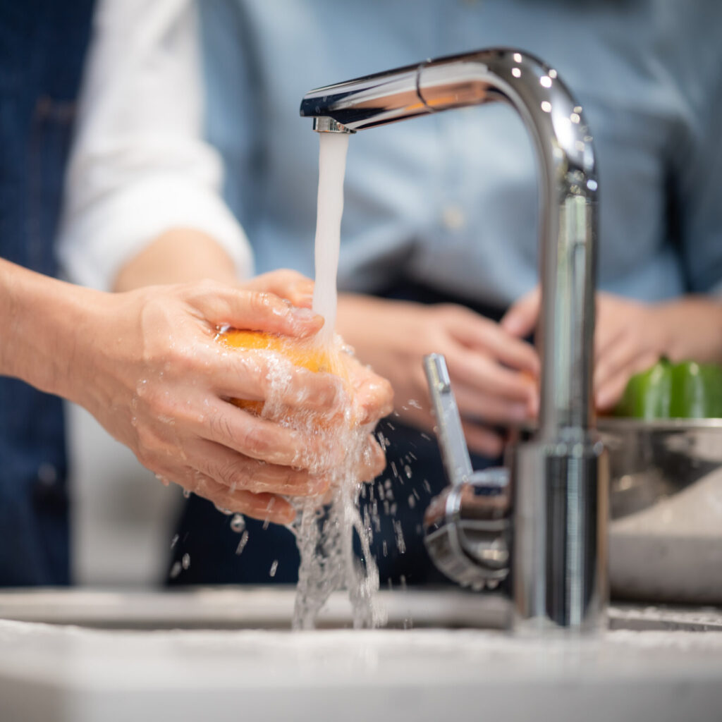 Washing vegetables and fruits for household hygiene.